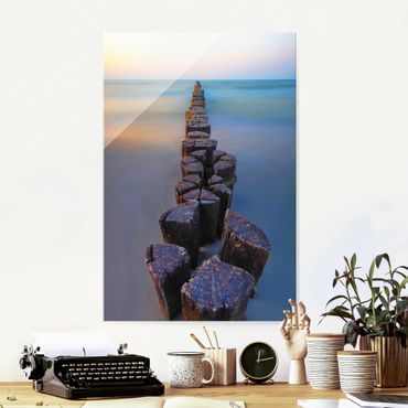 Glass print - Groynes At Sunset At The Ocean