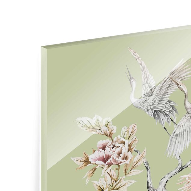 Tableaux Aquarelle - Cigognes en vol avec des fleurs sur un fond vert