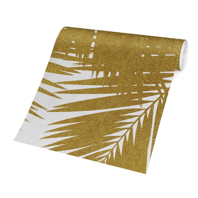 papier peint xxl Vue à travers des feuilles de palmier dorées