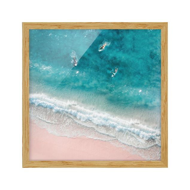 Tableau bord de mer Trois surfeurs pagayant vers le rivage