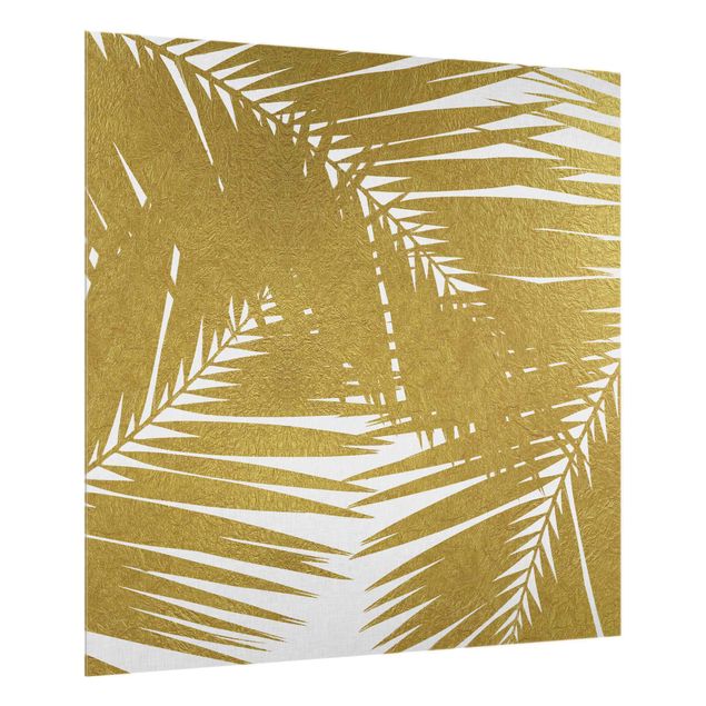 Fond de hotte verre Vue à travers des feuilles de palmier dorées
