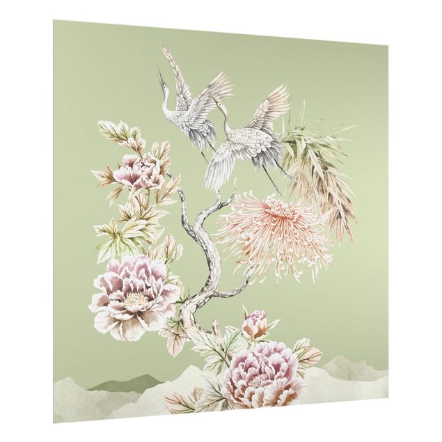 crédence cuisine en verre Aquarelle - Cigognes en vol avec des fleurs sur un fond vert